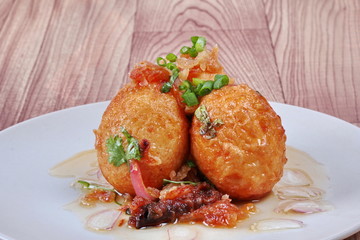 Close up,Fried hard-boiled eggs with tamarind sauce . Selective focus.
