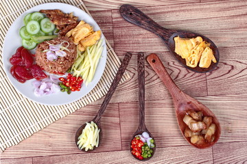 Fried jasmine rice with shrimp paste,(Kao Klok Kapi) with green mango roll,Chinese sausage,crispy dried fish,shrimp,chili,shallots,stir sweet pork,cucumber and scrambled egg .
