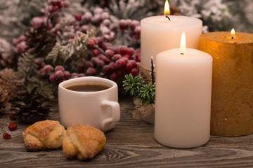 Obraz na płótnie Canvas Cup of coffee, cookies, candle, fir branch in snow on wooden background