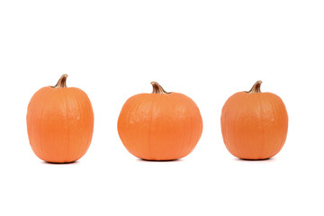 three orange pumpkins isolated white background