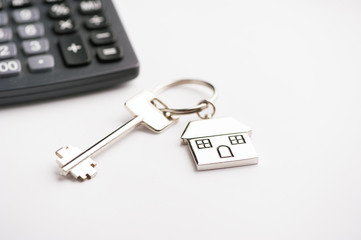 Key and house-shaped keyring and calculator - mortgage concept 