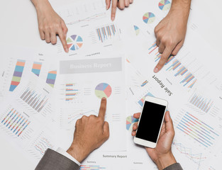 Business people hand pointing at business document in team meeting.