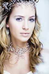 beauty young snow queen with hair crown on her head, complicate 