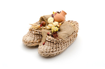 Bast shoes with products on a white background. The symbol of hearth and wealth.