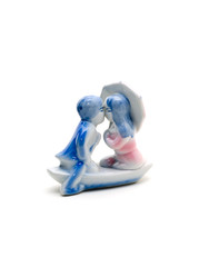 Kissing lovers. Ceramic figurine on a white background.