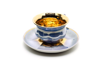 Empty small coffee cup on a saucer isolated on white background.