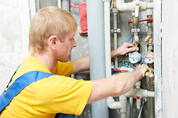 plumber man worker with spanner installing water meter