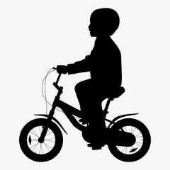 Fototapeta premium A boy rides a bicycle silhouette