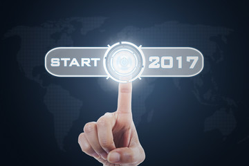 Hand presses button with 2017