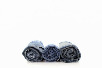 Rolls of blue Jeans isolated on white background.