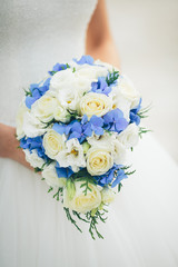 wedding bouquet in the hands of the bride