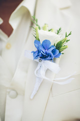 boutonniere flower on suit
