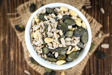 Old wooden table with mixed Seeds (selective focus)