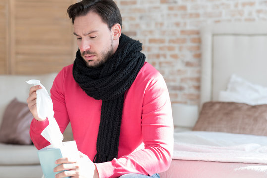 Sad Young Man Holding A Box Of Paper Tissues