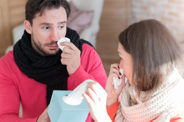 Sad depressed man giving his girlfriend a paper tissue