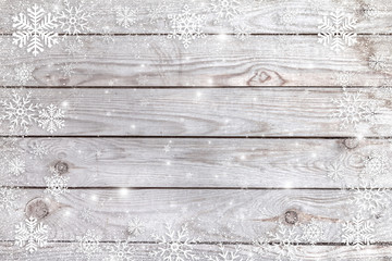 Snowflakes on a wooden background.