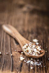 Wooden table with chopped Hazelnuts