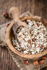 Wooden table with chopped Hazelnuts