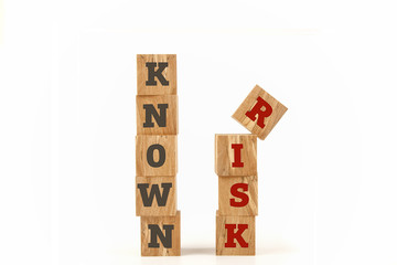 Known Risk message written on cube shape wooden surface isolated on white background.
