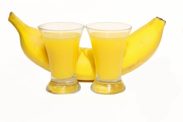 two shots with a bright yellow cocktail with banana flavor