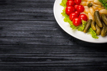 Pickled Vegetables on rustic wooden background