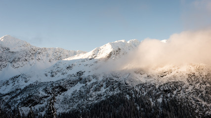 mountain tops in winter covered in snow