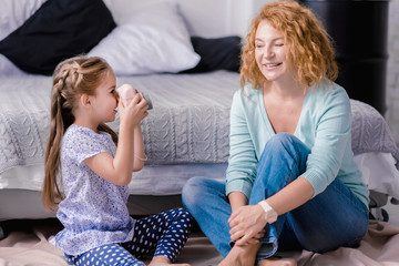 Merry granddaughter taking photos of her grandmother