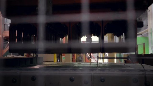 Brick Factory. Product Transportation. New Porting Arriving on Conveyer. Equipment Coming, Taking, Lifting, Bringing to Stack, Putting Bricks. Closeup