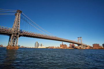 Williamsburg Bridge going from Manhattan to the Brooklyn side seen from the south in a low autumn sun