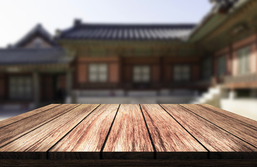 wooden table in front of blurred background of korean traditional house