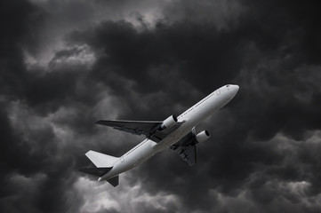 Fototapeta na wymiar airplane on stormy sky