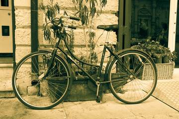 Fototapeta na wymiar Rusty Vintage Bicycle Background in sepia color
