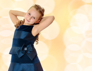Beautiful little girl dressed in a blue dress.