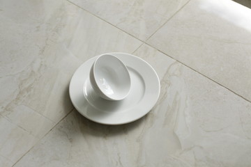 empty bowls, plates and cups on gray background