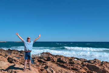 middle-aged man enjoying the warm sea breeze and stunning views of the ocean