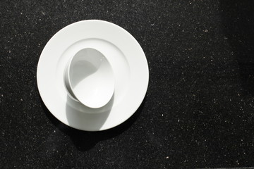 empty bowls, plates and cups on gray background