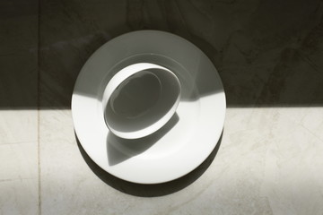 empty bowls, plates and cups on gray background