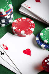 Obraz premium Playing cards, poker chips, and dices on green table