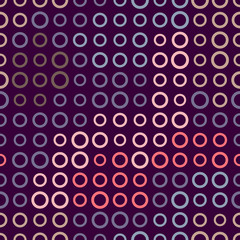 Seamless pattern of rings on a dark background.