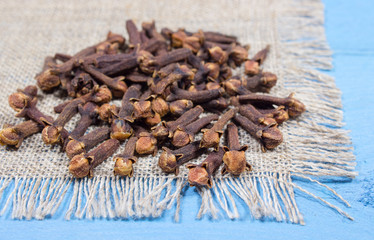 Cloves on a blue board.