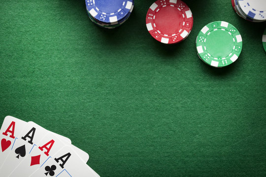 Poker background - chips and cards on green table