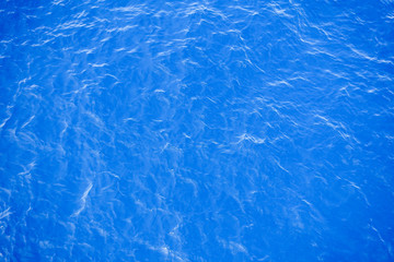 Flowing water surface of blue sea.