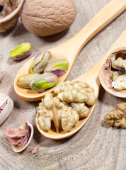 Closeup of a walnut and pistachios.