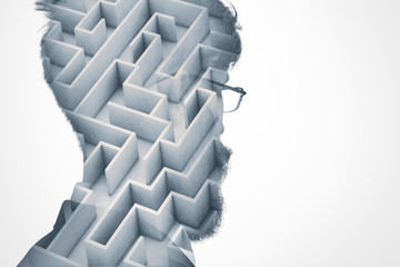 Double exposure of man's head silhouette with maze on white wall background with copy space for...