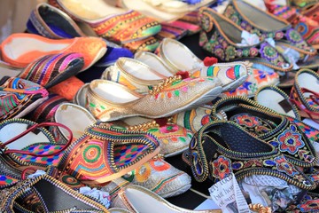 Fototapeta na wymiar shoes on Indian market stall various embroidered