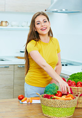 woman in kitchen cooking vegetables. smiling young woman