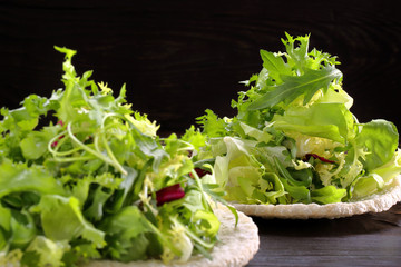 Fresh green salad mix on black background