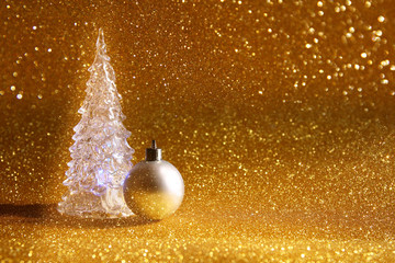 christmas glowing tree and decorations on glitter background
