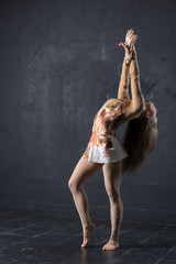 Naklejka premium Elegant woman dance in dark studio