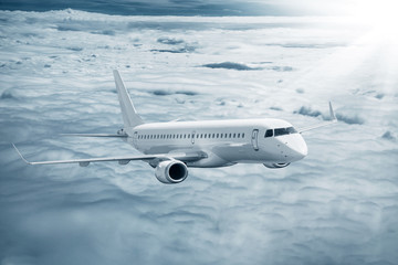Fototapeta na wymiar White airplane flying higher clouds at daytime